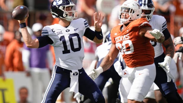 BYU Cougars quarterback Kedon Slovis throws under press ure from Texas Longhorns defensive lineman Byron Murphy II in the first quarter at Royal-Memorial Stadium on Saturday October 28, 2023.  